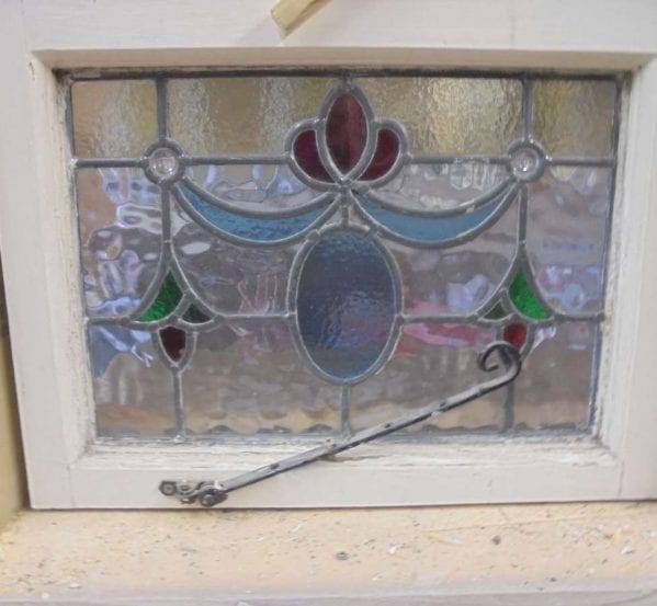 Multi-coloured stain glass window with latch